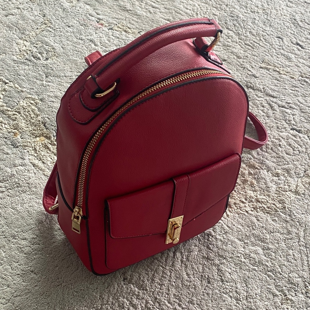 Red leather/black piping Backpack with Gold Accents. Never used in excel. cond.